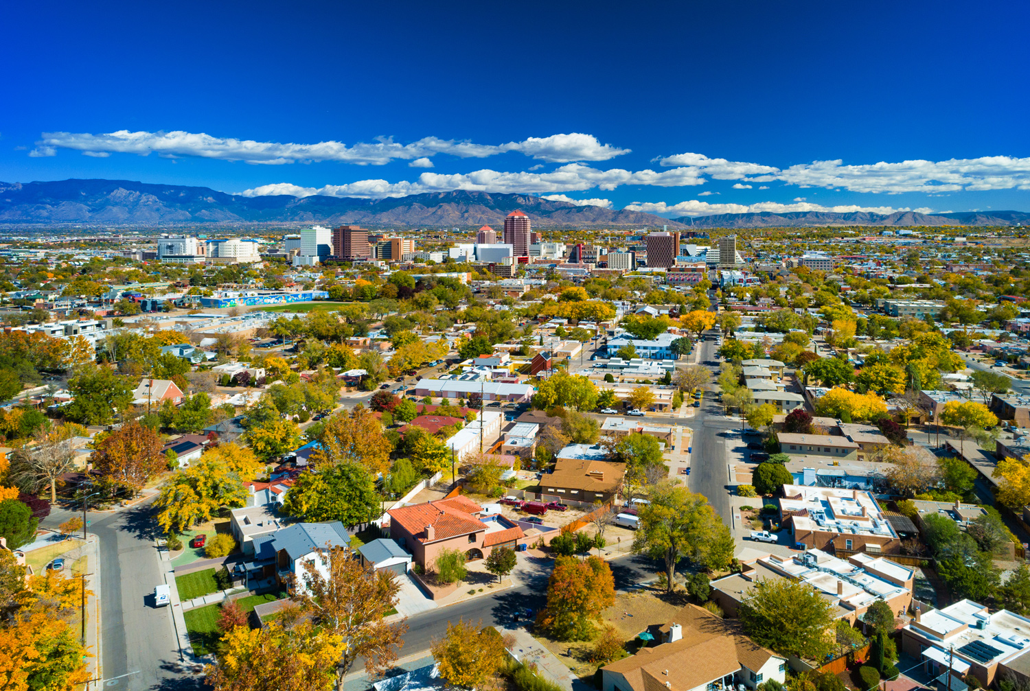 Aerial view of Albuquerque cityscape and mountains.