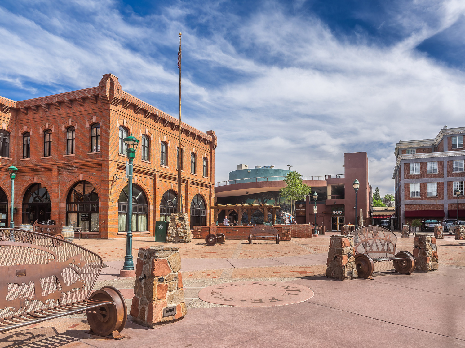 Historic brick building in Flagstaff city square, blue sky overhead.