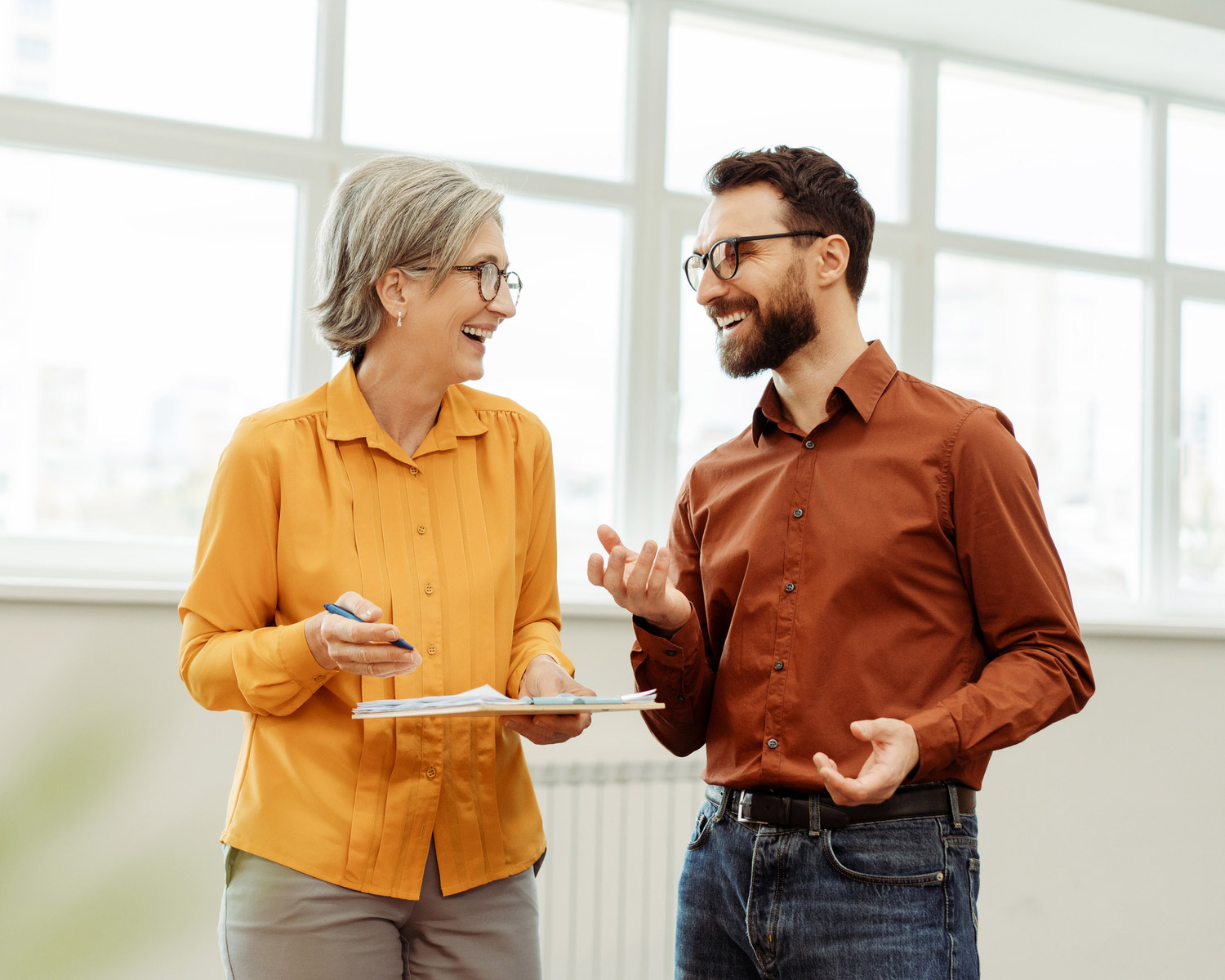 Two people discussing in a bright office.