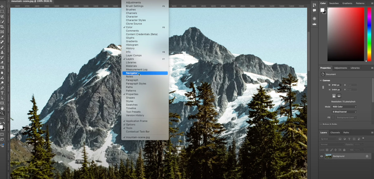 Photoshop interface with mountain scene open.